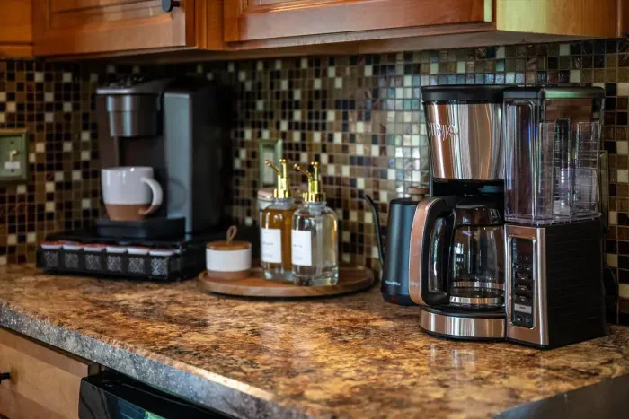 Coffee bar with Ninja drip, Keurig, ground coffee, and pods provided.