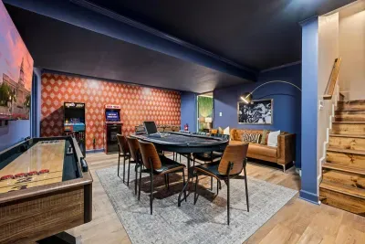 The basement game room features shuffleboard, arcade games, poker, and foosball.