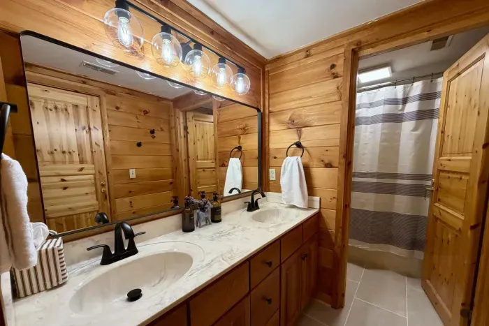 Shared upstairs bathroom with a tub and shower combination.
