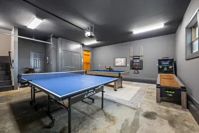 The garage game room features billiards, table tennis, darts, and roll ball.