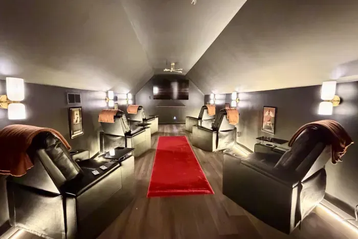Private theater with reclining seats and trays for movie nights.
