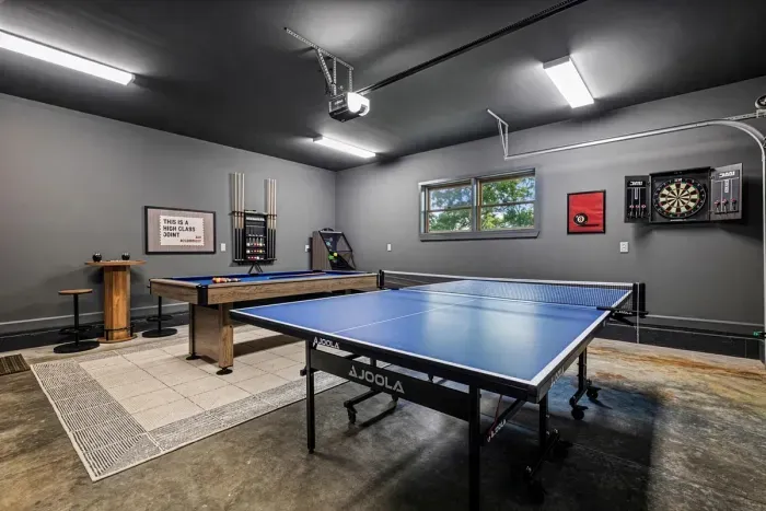 Friendly competition starts here with billiards, table tennis, darts, and roll ball in the garage game room.