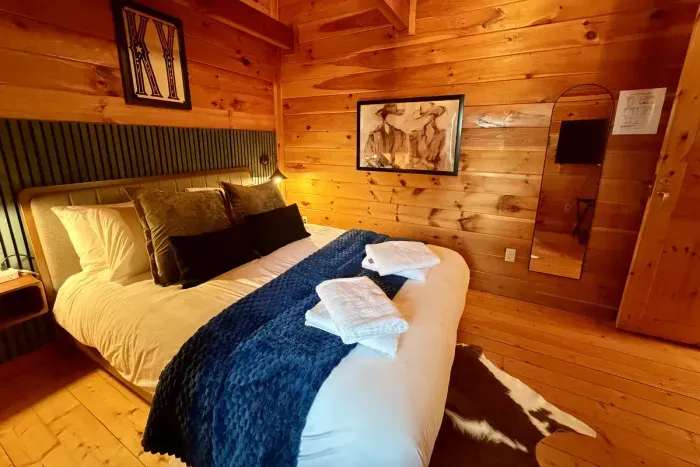 Cozy second-floor queen bedroom featuring a Roku TV.