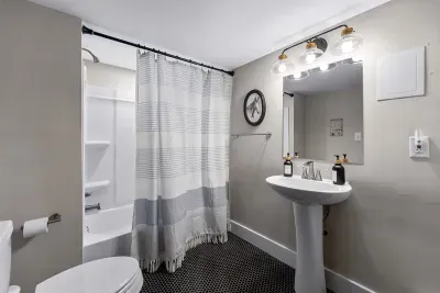 This full bathroom is located in the basement which is very convenient for those hanging out in the game room and/or speakeasy