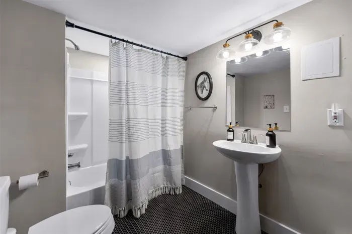 This full bathroom is located in the basement which is very convenient for those hanging out in the game room and/or speakeasy