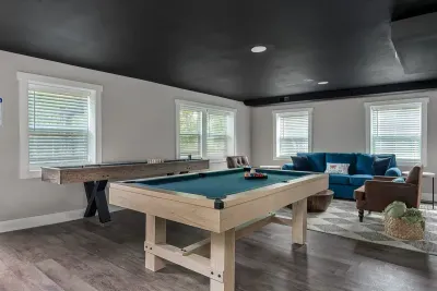 The game room is fully equipped with a pool table, shuffleboard, board games and other fun activities