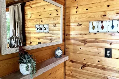 We've accessorized this tiny home with the all the amenities you need. A large mirror, plenty of outlets, shelves, hairdryer, fluffy towels and hooks to make your stay pleasant and functional.