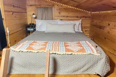This lofted bedroom provides a cozy atmosphere surrounding you with twinkle lights spanning the perimeter of the loft. A perfect relaxing place to escape the pressures of life and have a restful getaway. Black-out curtains ensure deep long sleep.