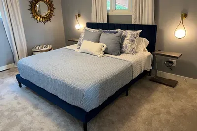 Inspired by the home's natural setting, the interior colors mimic the outdoors. This king suite is painted in "Morning Fog" creating the serene feeling of a quiet fog blanketing the water.