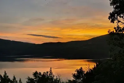 As you stand on the deck, to your right, the mountainside unveils the breathtaking beauty of Mark Twain's National Forest. Shell Knob, Missouri, known as the serene side of Table Rock lake, whether you're admiring the peaceful waters from a distant deck or