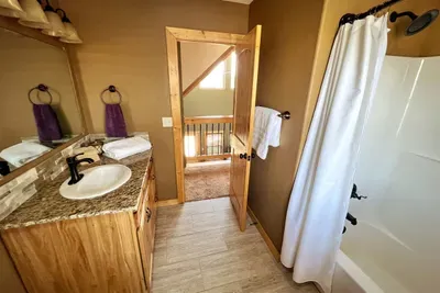 Large 2nd floor bath, full tub and shower. All showers are supplied by an instant electric water heater than never runs out of hot water To be sure we always have hot water we added a 50 gallon conventional heater for the remainder of the house.