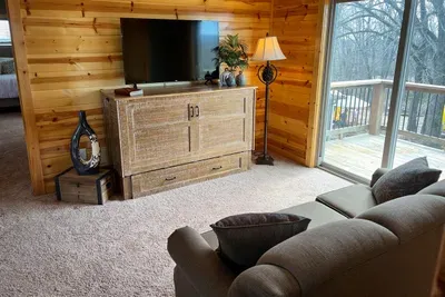 Another TV, a couch for a nap or a good book. The natural light streams in from the deck just outside the sliding glass door. Whether you sneak upstairs or even outside, the "Pinecone Pier" is a good secret hideaway! Did someone say "hideaway"?