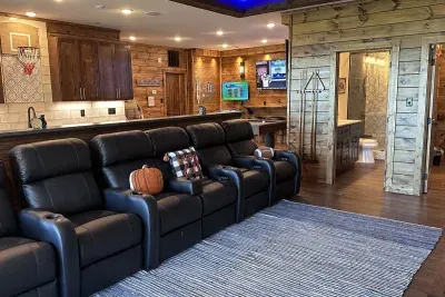 5 Leather Recliners with bar behind with 6 barstools for plenty of seating.