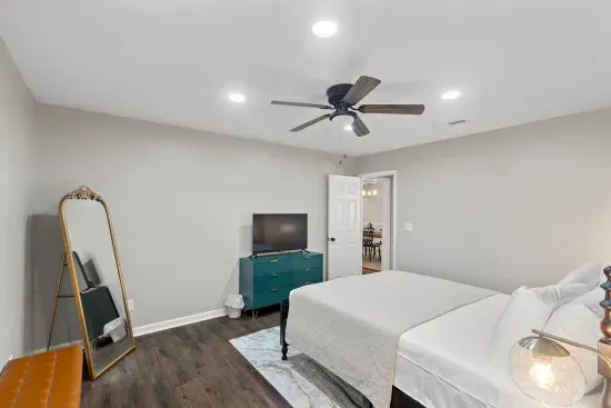 the master bedroom has room to relax and a smart tv.