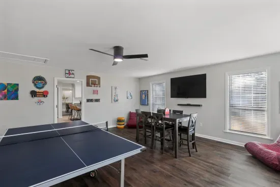 The game room is set up for fun with card games, ping pong, a tv and more.
