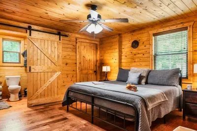 Primary bedroom with King bed, ensuite bathroom and washer/dryer combo in closet.