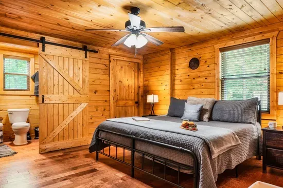 Primary bedroom with King bed, ensuite bathroom and washer/dryer combo in closet.