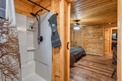 The master bedroom offers a standing shower with a built in bench.