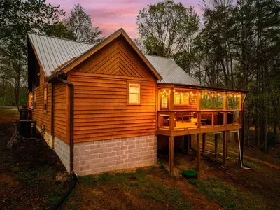 Back porch with ambient string lighting and ample seating.