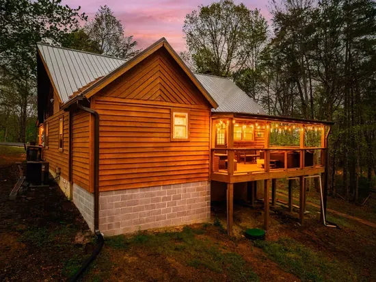 Back porch with ambient string lighting and ample seating.