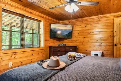 The large guest bedroom has plenty of space, a comfy king bed & a 55 inch TV.
