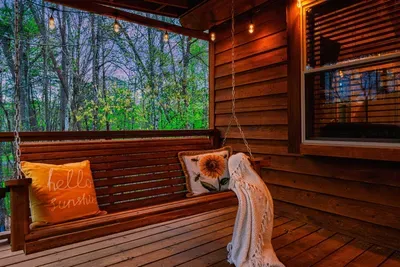 The two porch swings offer a relaxing outdoor experience.