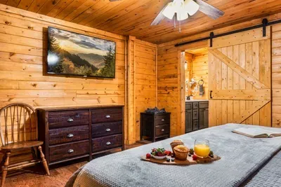 The primary bedroom offers a 55 inch tv, ensuite bathroom and laundry room.