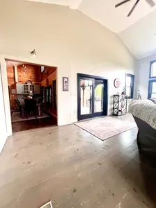 Spacious living room with a huge TV and an indoor firepit