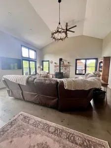 Spacious living room with a huge TV and an indoor firepit