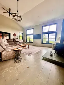 Spacious living room with a huge TV and an indoor firepit
