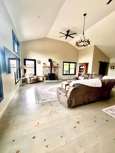 Spacious living room with a huge TV and an indoor firepit