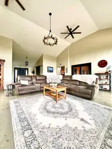 Spacious living room with a huge TV and an indoor firepit