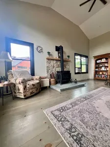 Spacious living room with a huge TV and an indoor firepit