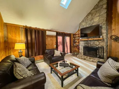 Cozy living room with a huge TV and an indoor fireplace