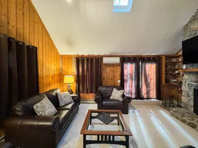 Cozy living room with a huge TV and an indoor fireplace