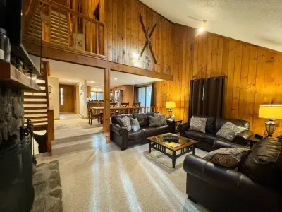 Cozy living room with a huge TV and an indoor fireplace