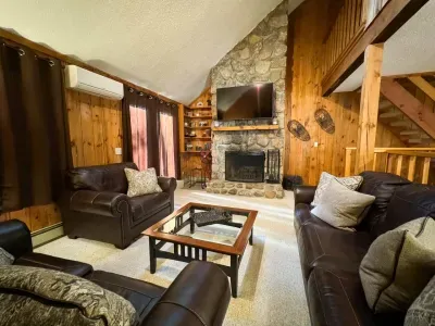 Cozy living room with a huge TV and an indoor fireplace