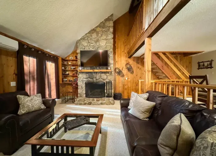 Cozy living room with a huge TV and an indoor fireplace