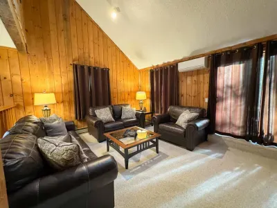 Cozy living room with a huge TV and an indoor fireplace