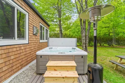 Cozy outdoor hot tub surrounded by nature — perfect for relaxing after a day of adventure.