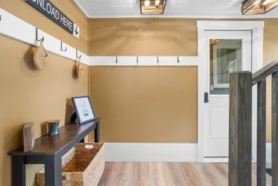 Welcoming entryway with convenient hooks and storage — the perfect spot to unload and settle in