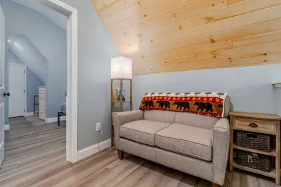 Upstairs cozy couch area in the loft, with books available to read!