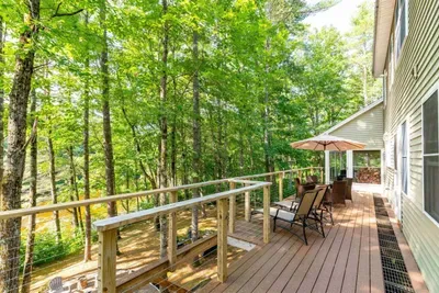 Spacious deck with serene woodland views.