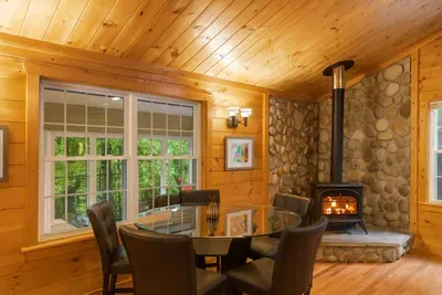 This table is a great spot to dine, or play a game of cards. The windows behind it view to the enclosed porch over looking the backyard.