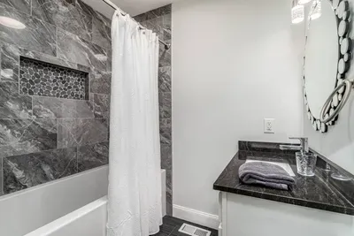 This bathroom is on the mid level, adjacent to the kitchen and queen and twin bedrooms on this floor. It has a full bath tub.