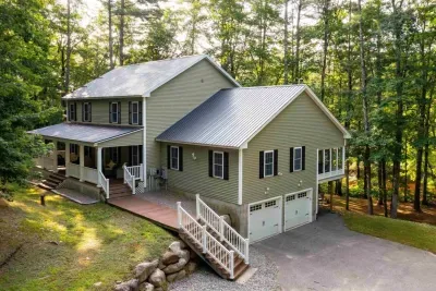 Charming home surrounded by tall trees and natural beauty.