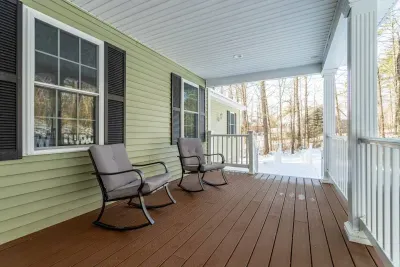 Quiet front porch with rocking chairs and a swing.
