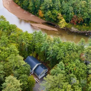 Private riverside retreat surrounded by peaceful forest.