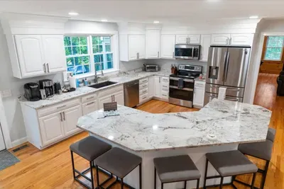 This fully equipped kitchen is perfect for winter stays—ideal for skiers! Spacious counters, an organized coffee station, with snowy views for meals, and group cooking. Complete coffee station, drip machine, Keurig, espresso maker, and kettle.