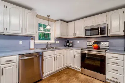 Fully Equipped Kitchen: Everything you need to cook and dine in—stocked with cookware, dishes, utensils, and modern appliances. The dining table seats six, plus bar seating for four.